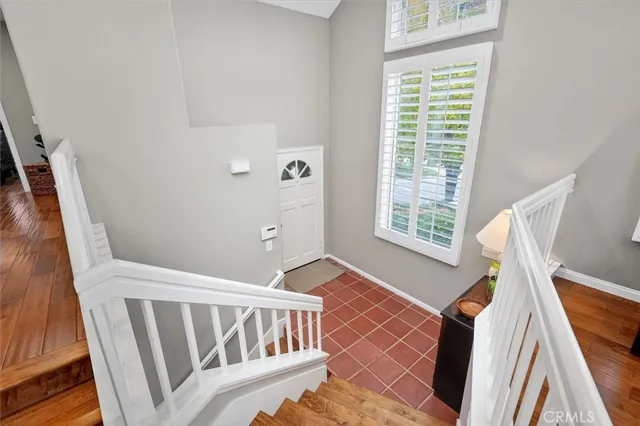 a view of a bedroom with wooden floor and windows