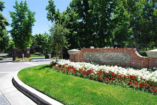 a garden view with plants and large trees