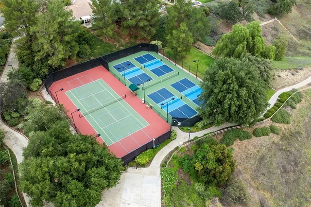 an aerial view of a tennis ground and a yard