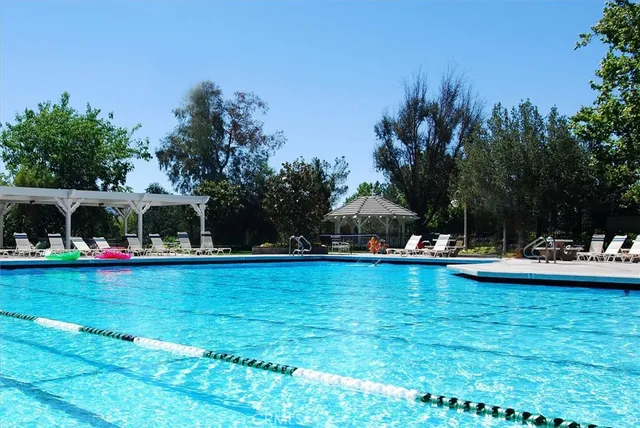 a view of swimming pool and deck in the backyard