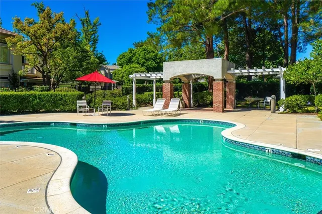a view of a house with swimming pool and sitting area