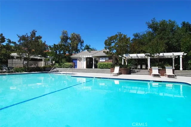 a view of house with swimming pool and furniture