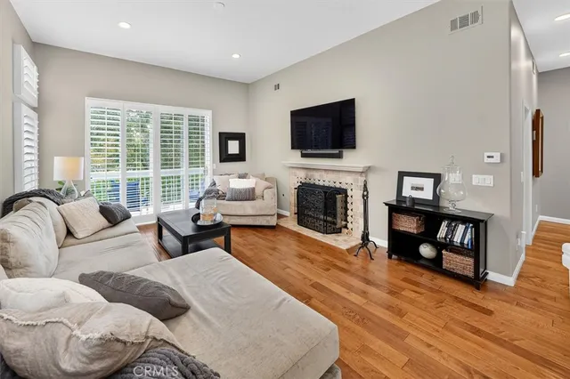 a living room with furniture fireplace and flat screen tv
