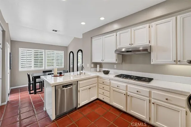 a kitchen with a sink stove and cabinets