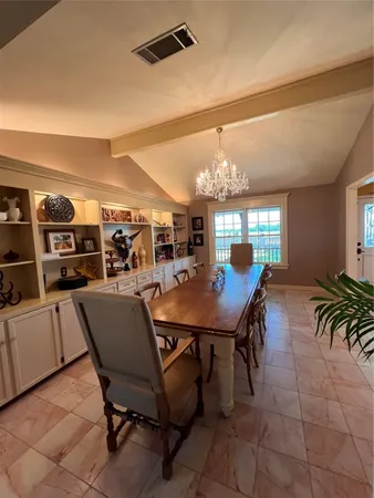 a view of a dining room and livingroom with furniture wooden floor and a rug