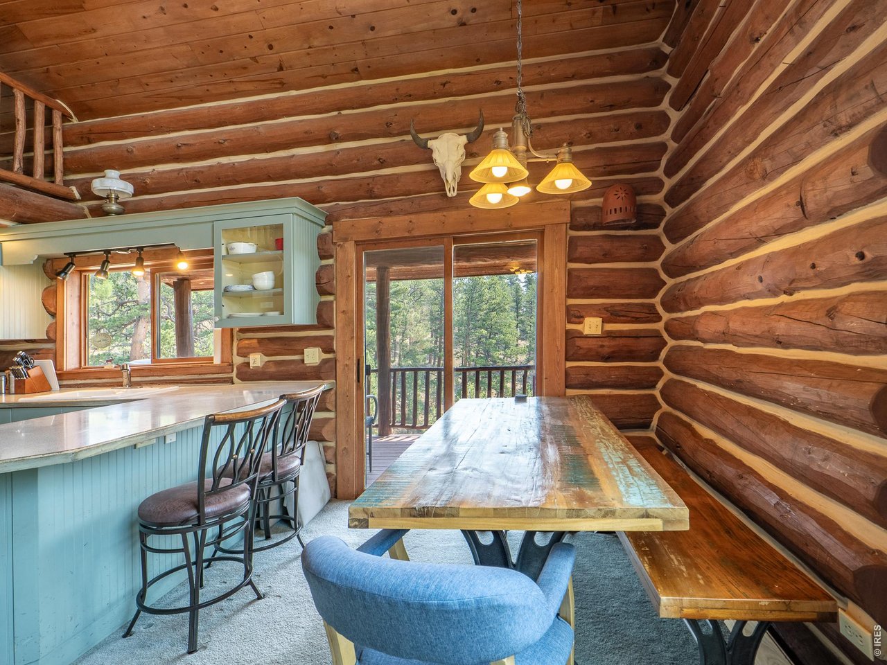 296 Caddo Road Red Feather Lakes, CO 80545 - Photo 7 of 50 Dining area and deck access.