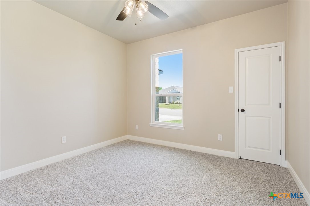 3824 Keller Road Temple, TX 76504 - Photo 21 of 28 an empty room with a window and a ceiling fan