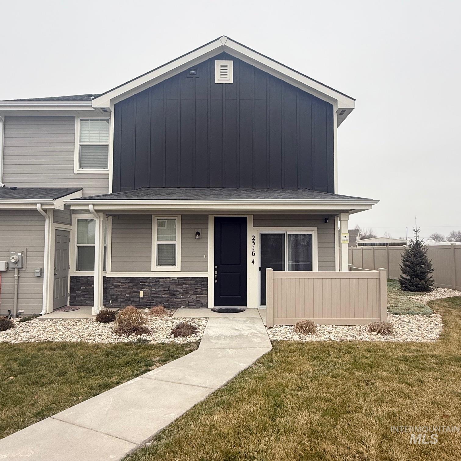 2316 East Spice Loop, Unit 4 Nampa, ID 83687 - Photo 1 of 12 View of front of property featuring a porch, stone siding, and board and batten siding