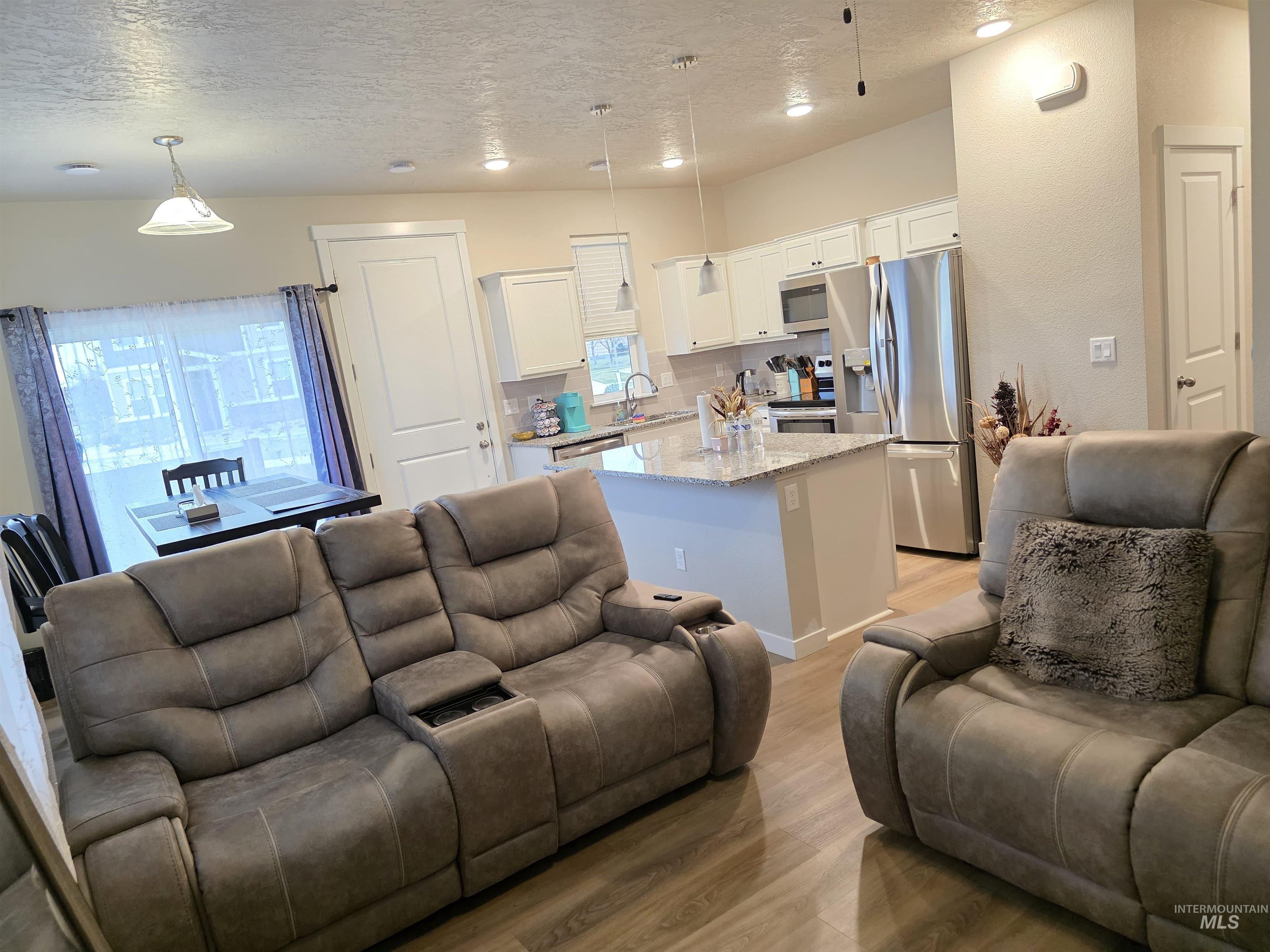 2316 East Spice Loop, Unit 4 Nampa, ID 83687 - Photo 4 of 12 Living room with a textured ceiling and light wood finished floors