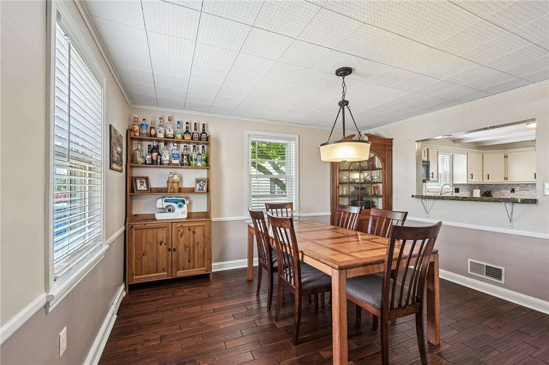 4065 Airport Road Allentown, PA 18109 - Photo 6 of 28 Rich hardwood floors complement this bright dining space, offering both comfort and connection to the adjacent kitchen.