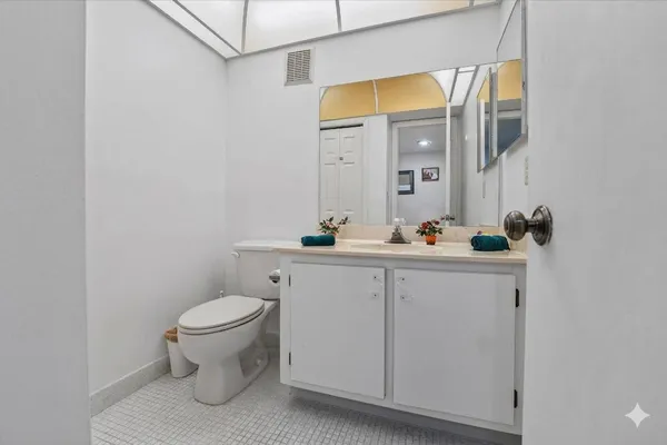 a bedroom with a bed a table and a bookshelf