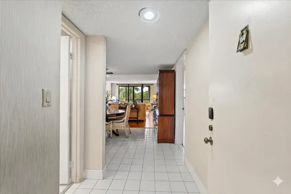 a view of a dining room with furniture and a chandelier