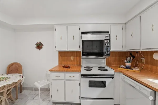a kitchen with a sink stove and white stainless steel appliances