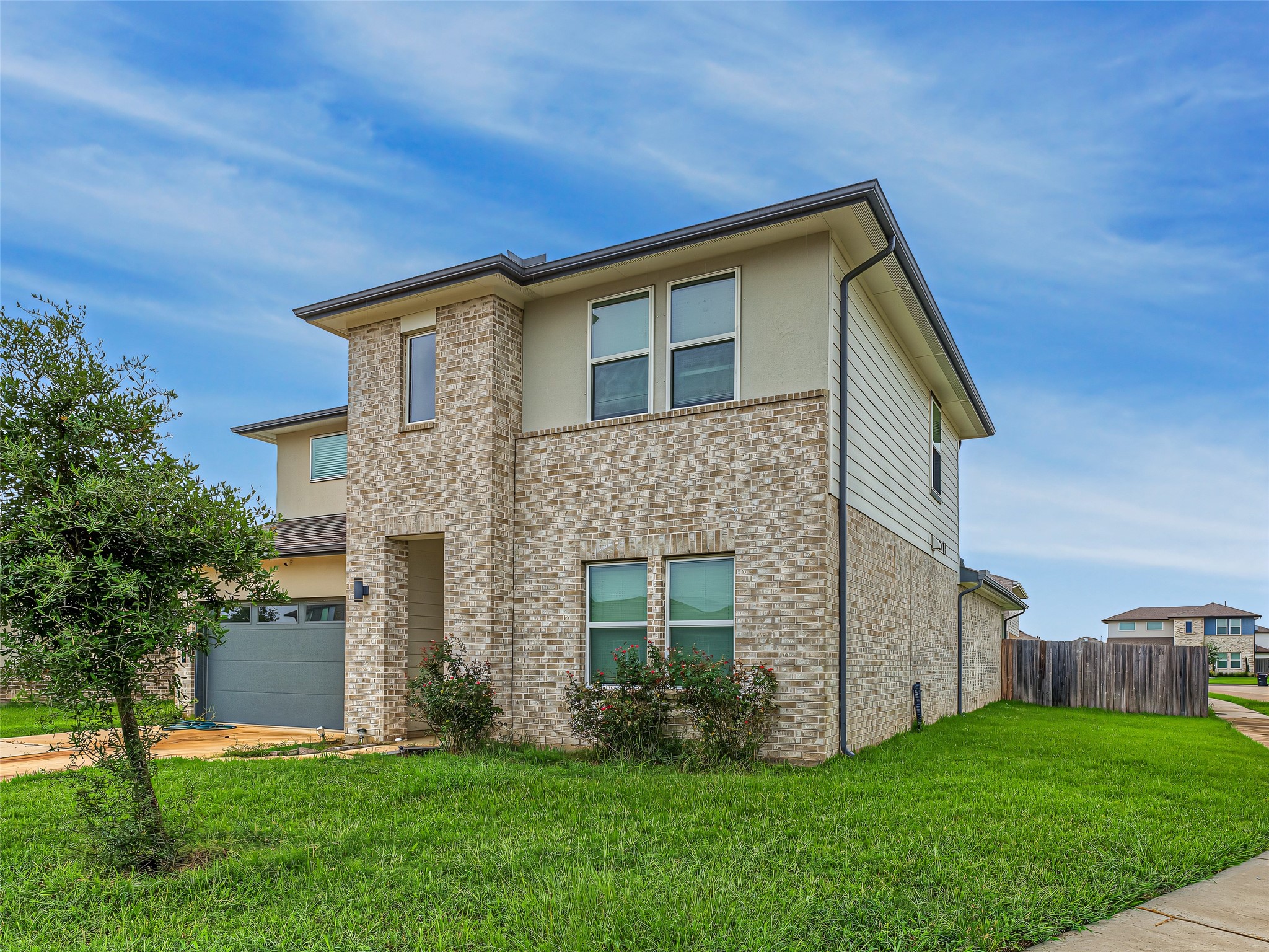 8043 Milam Lane Rosharon, TX 77583 - Photo 2 of 41 A concrete driveway and lush green lawn frame this exquisite property, making it an inviting place to call home. Oversized corner lot so you only have neighbors on one side and easy access in and out