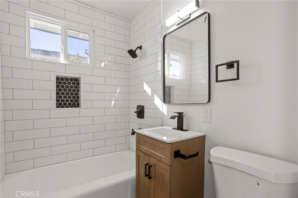 1290 Lomita Road San Bernardino, CA 92405 - Photo 21 of 29 a bathroom with a sink a toilet and mirror