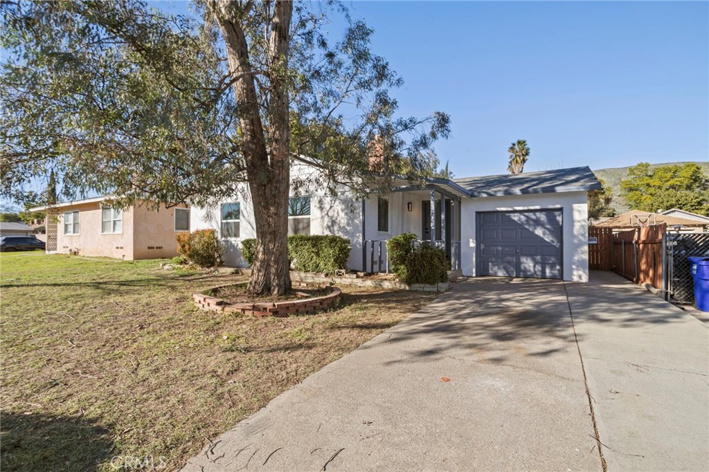 1290 Lomita Road San Bernardino, CA 92405 - Photo 4 of 29 a front view of a house with garden and tree
