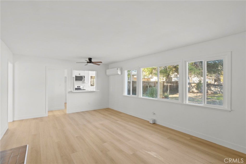 1290 Lomita Road San Bernardino, CA 92405 - Photo 5 of 29 a view of empty room with wooden floor and fan
