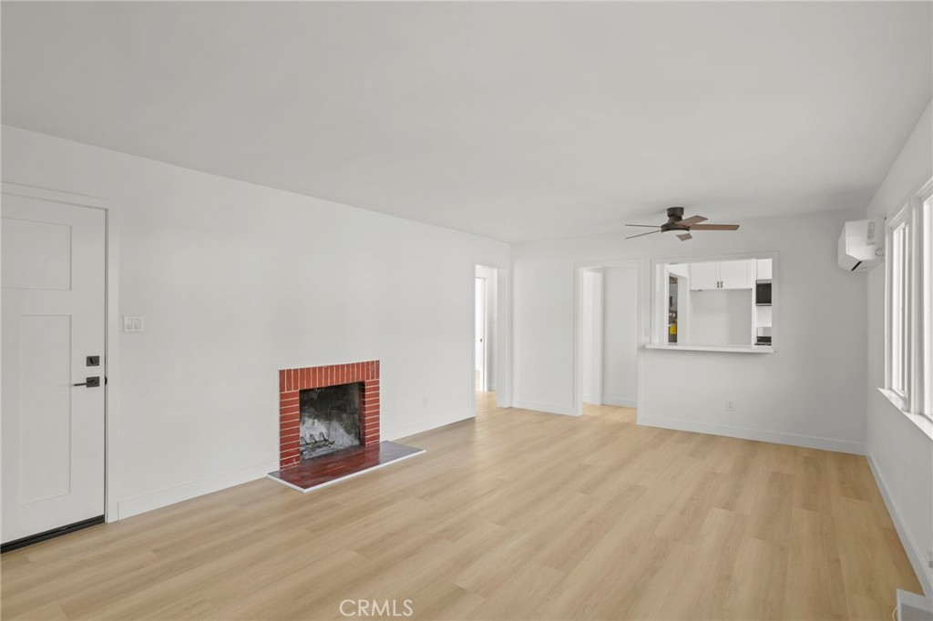 1290 Lomita Road San Bernardino, CA 92405 - Photo 6 of 29 a view of an empty room with wooden floor and windows