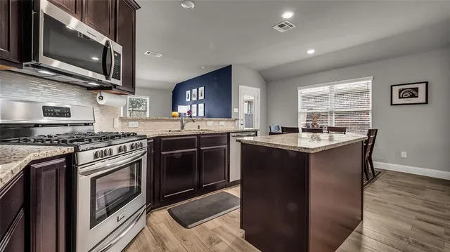 a kitchen with a sink stove and microwave