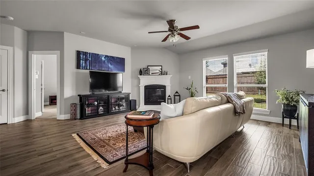a living room with furniture a fireplace and a flat screen tv