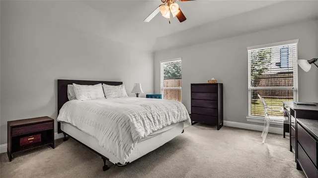 a bedroom with a bed and a television