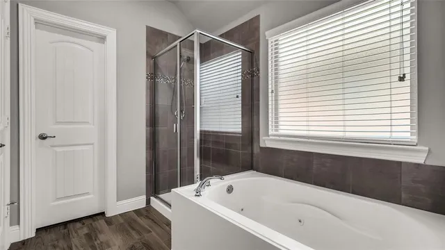 a bathroom with a bathtub and a window