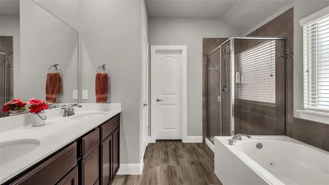 a bathroom with a tub sink and mirror