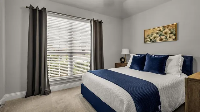 a bed sitting in a bedroom next to a window