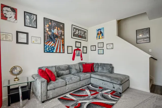 a living room with furniture and painting on the wall