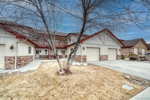 a view of a house with a yard covered in snow