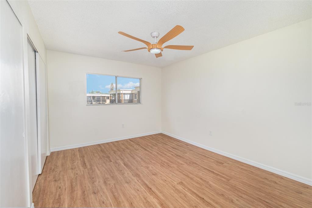 1000 Lake Of The Woods Boulevard, Unit E206 Fern Park, FL 32730 - Photo 11 of 17 a view of a big room with wooden floor and a ceiling fan