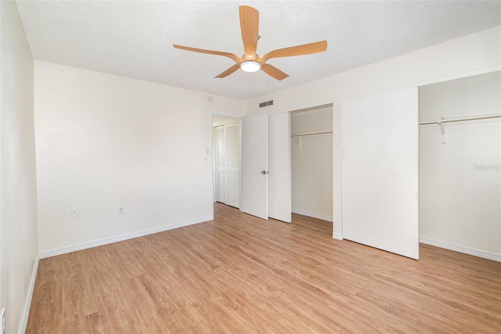 1000 Lake Of The Woods Boulevard, Unit E206 Fern Park, FL 32730 - Photo 12 of 17 a view of an empty room with wooden floor and a ceiling fan