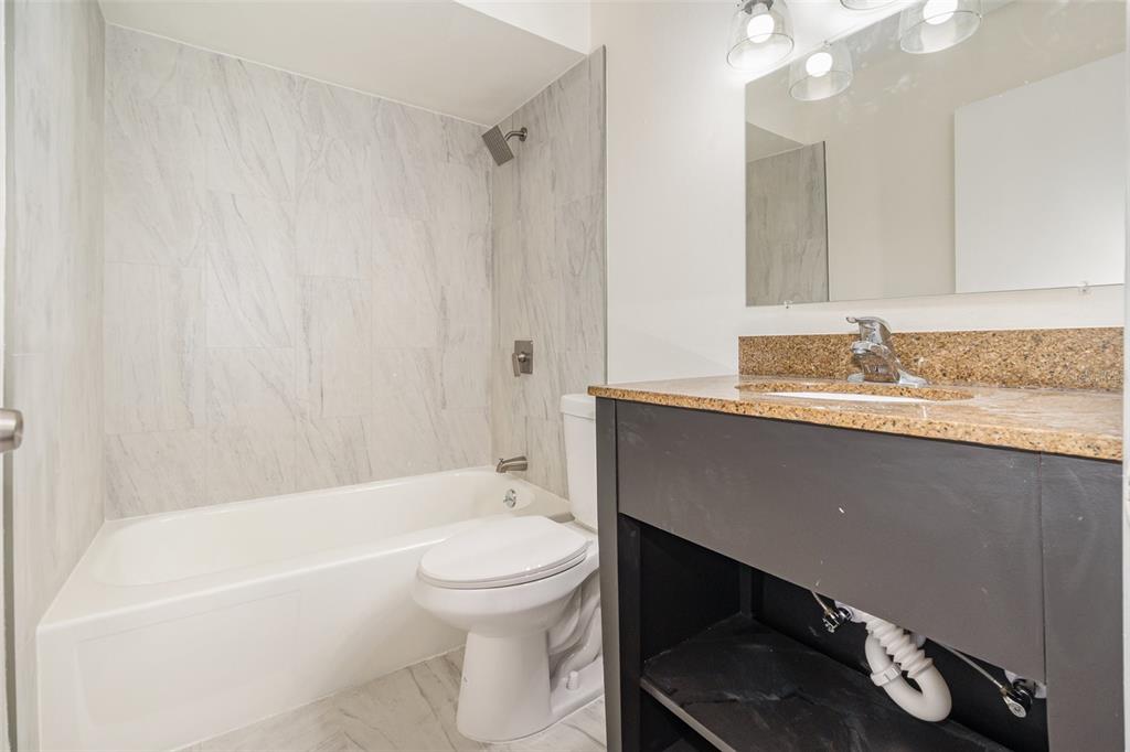 1000 Lake Of The Woods Boulevard, Unit E206 Fern Park, FL 32730 - Photo 14 of 17 a bathroom with a sink a toilet and bathtub