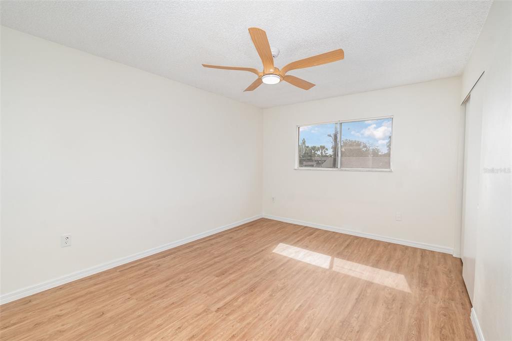 1000 Lake Of The Woods Boulevard, Unit E206 Fern Park, FL 32730 - Photo 9 of 17 an empty room with wooden floor and windows