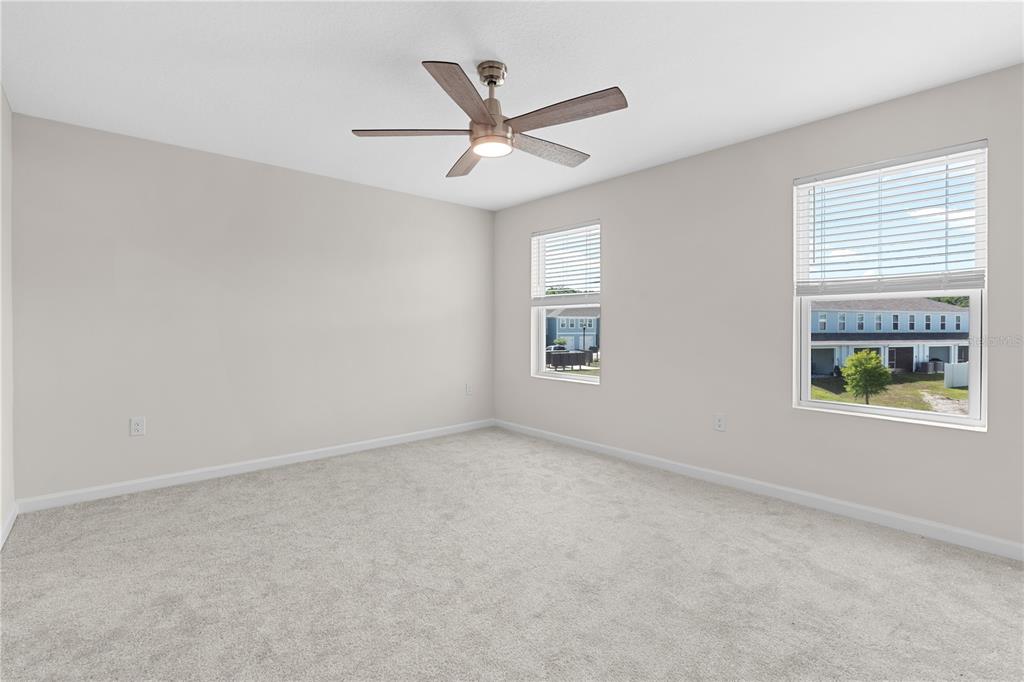 12003 Grizzly Lane New Port Richey, FL 34654 - Photo 27 of 43 an empty room with a window and a ceiling fan