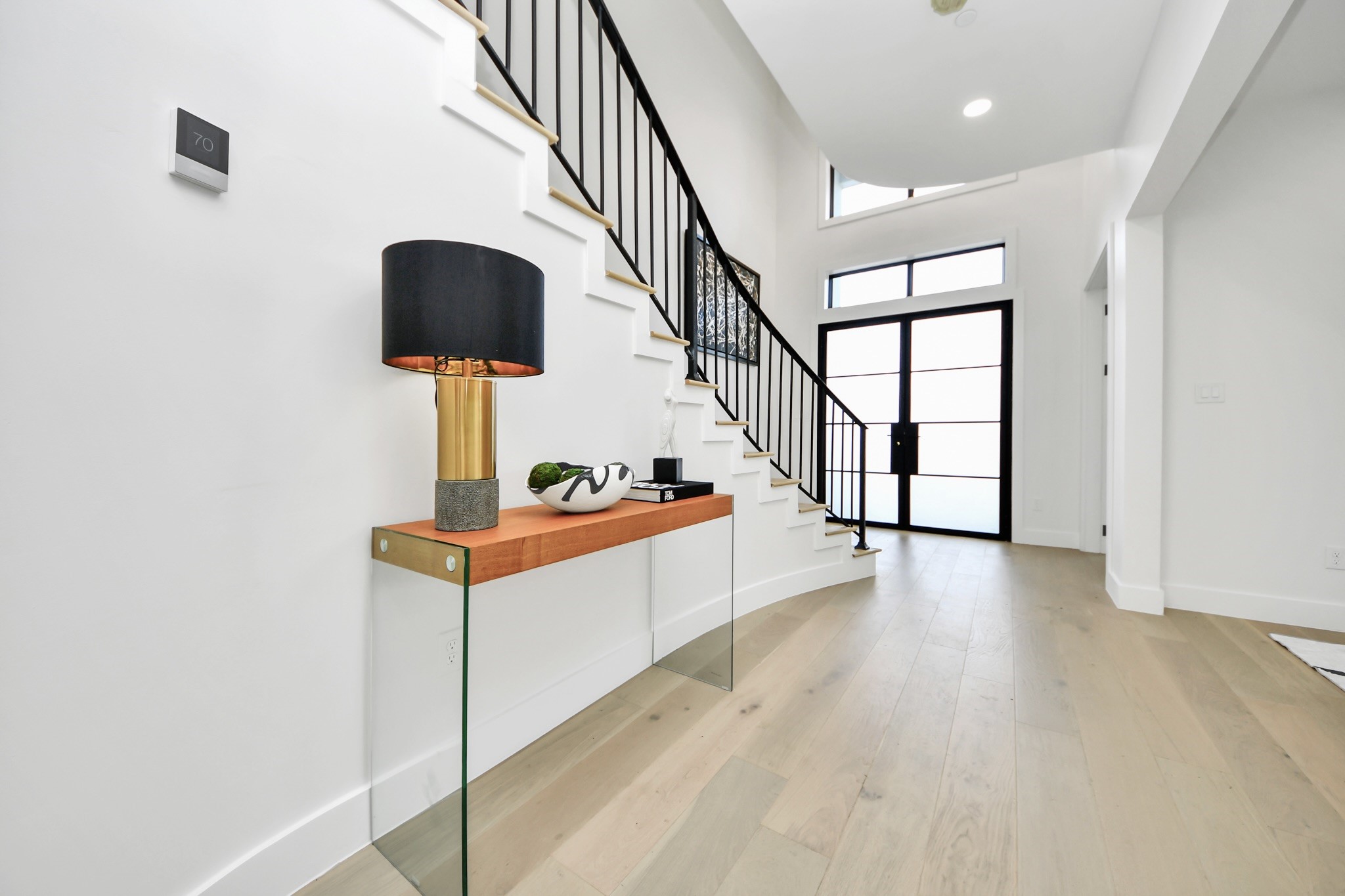 5115 Maple Street Bellaire, TX 77401 - Photo 24 of 45 The grand foyer features generous proportions and a welcoming flow, setting the stage for the home’s luxurious design.