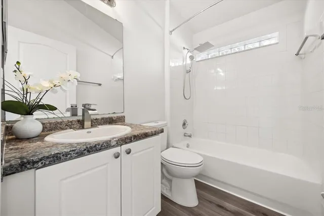 an empty room with a ceiling fan and window