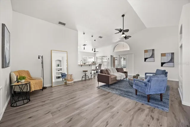 a living room with furniture and wooden floor