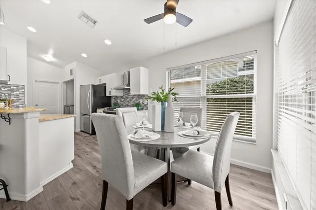 a dining room with furniture and window