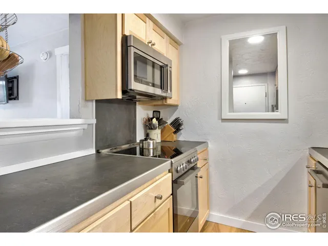 a kitchen with stainless steel appliances granite countertop a sink and a microwave