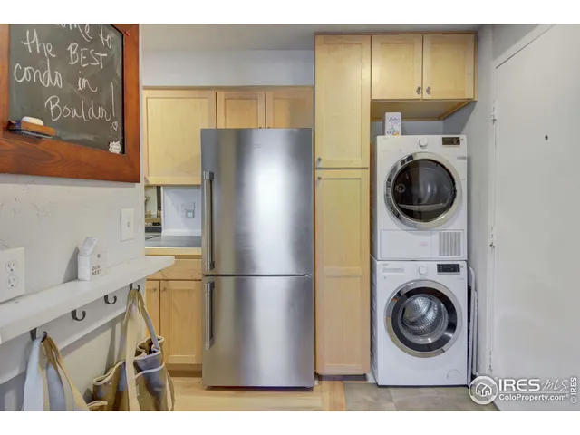 a kitchen with a refrigerator and washer