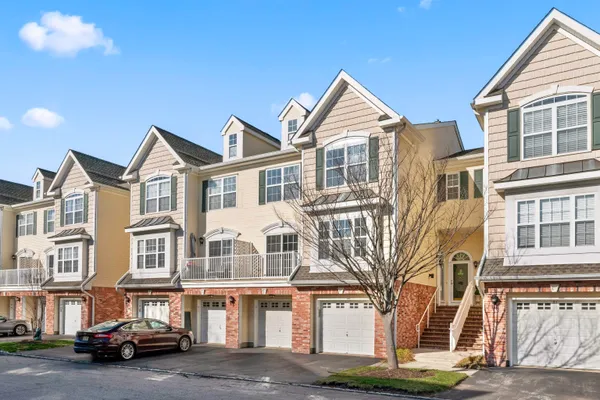 a front view of a residential apartment building with a yard