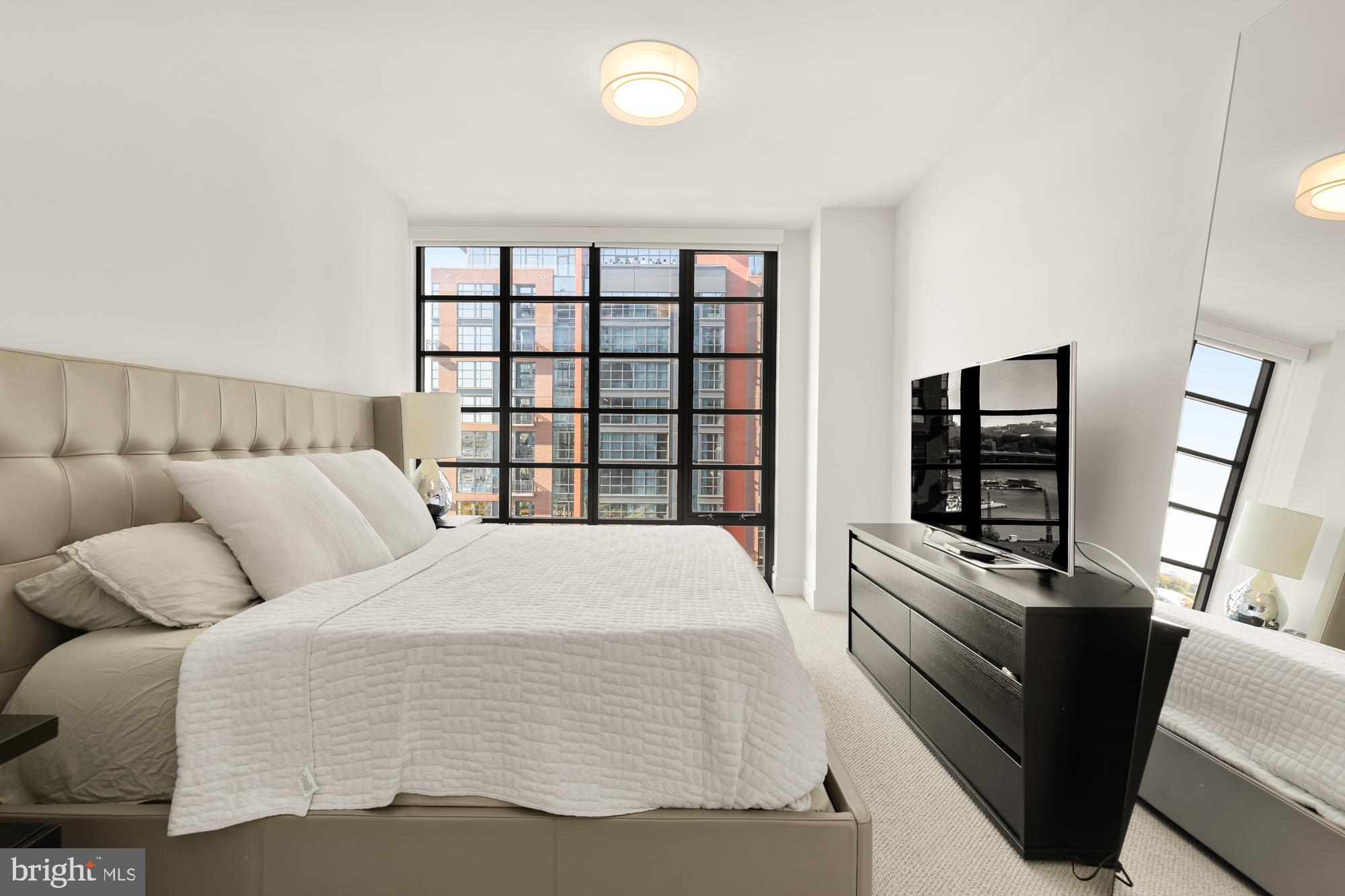 45 Sutton Square Southwest, Unit 706 Washington, DC 20024 - Photo 17 of 51 a bedroom with a bed and a television