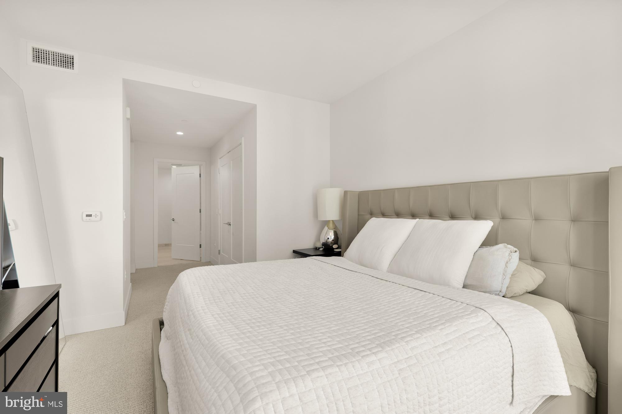 45 Sutton Square Southwest, Unit 706 Washington, DC 20024 - Photo 19 of 51 a bedroom with a bed and a night stand