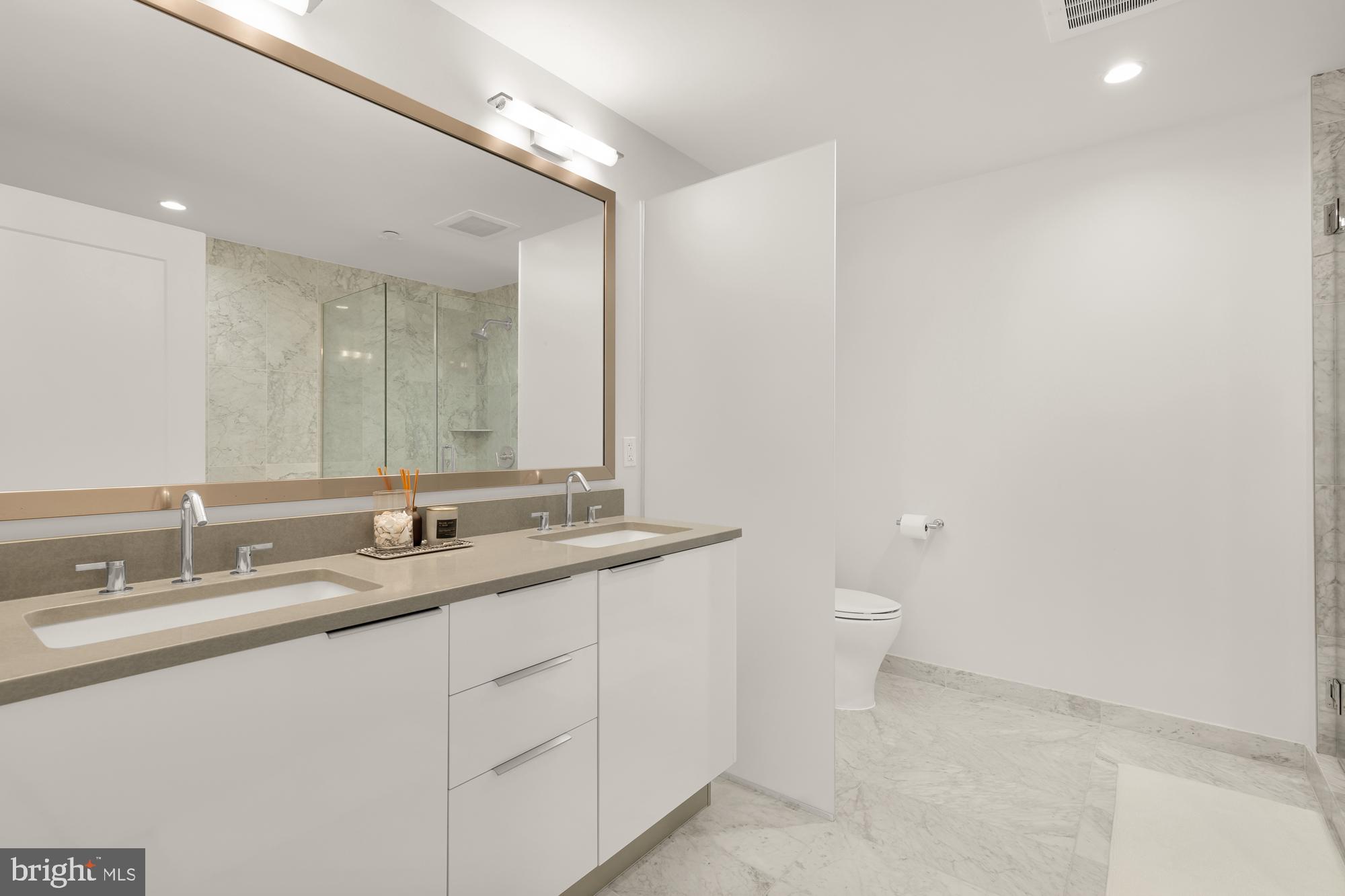 45 Sutton Square Southwest, Unit 706 Washington, DC 20024 - Photo 21 of 51 a bathroom with a double vanity sink and a mirror