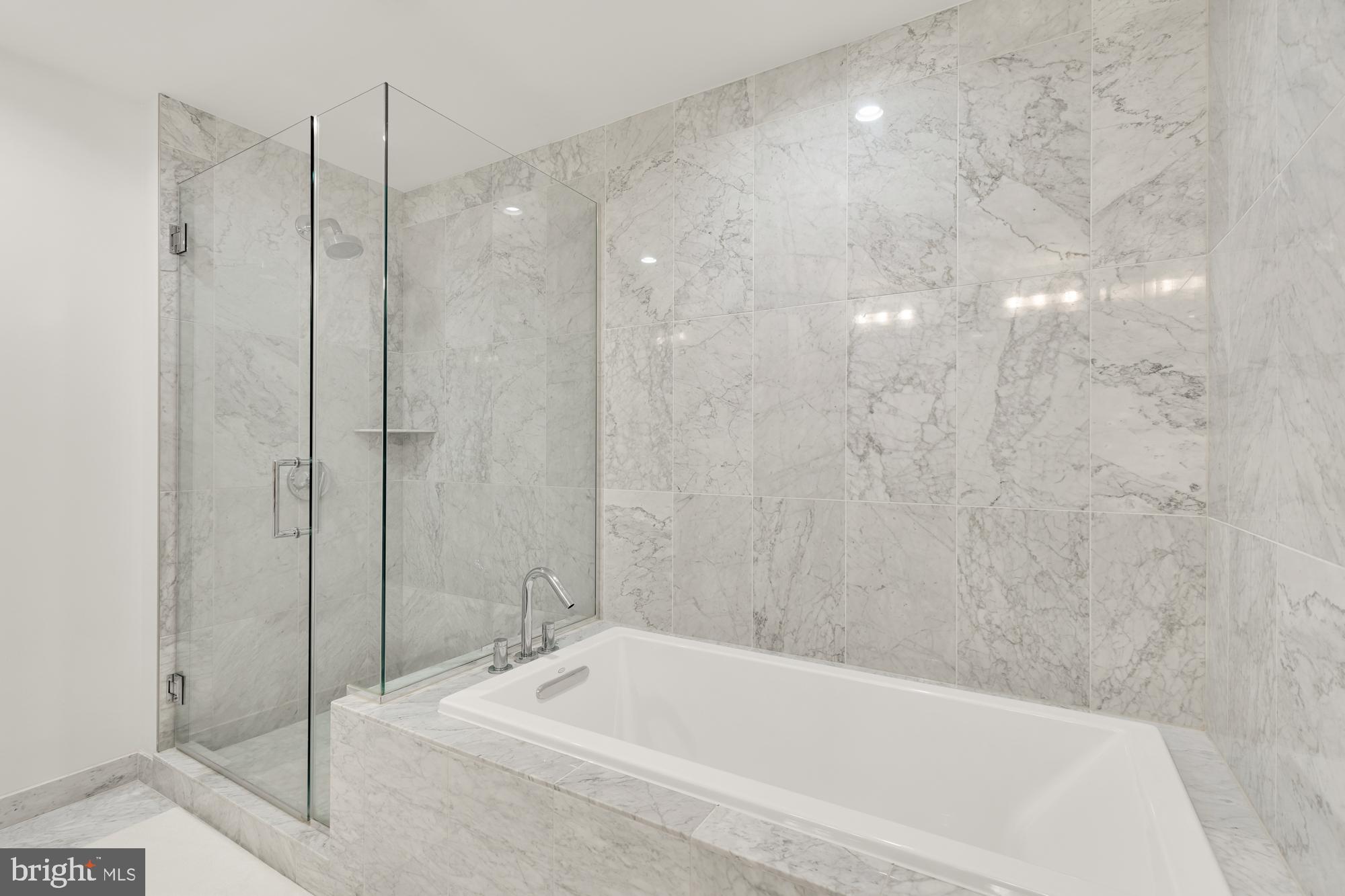 45 Sutton Square Southwest, Unit 706 Washington, DC 20024 - Photo 22 of 51 a bathroom with a bathtub and a shower