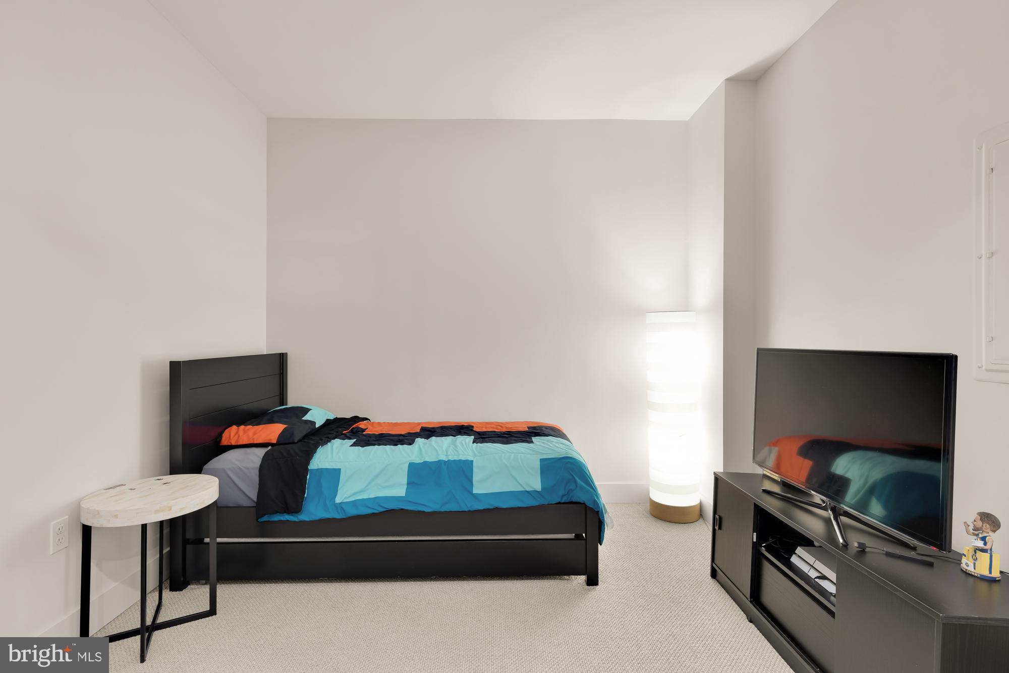 45 Sutton Square Southwest, Unit 706 Washington, DC 20024 - Photo 28 of 51 a bedroom with furniture and a flat screen tv