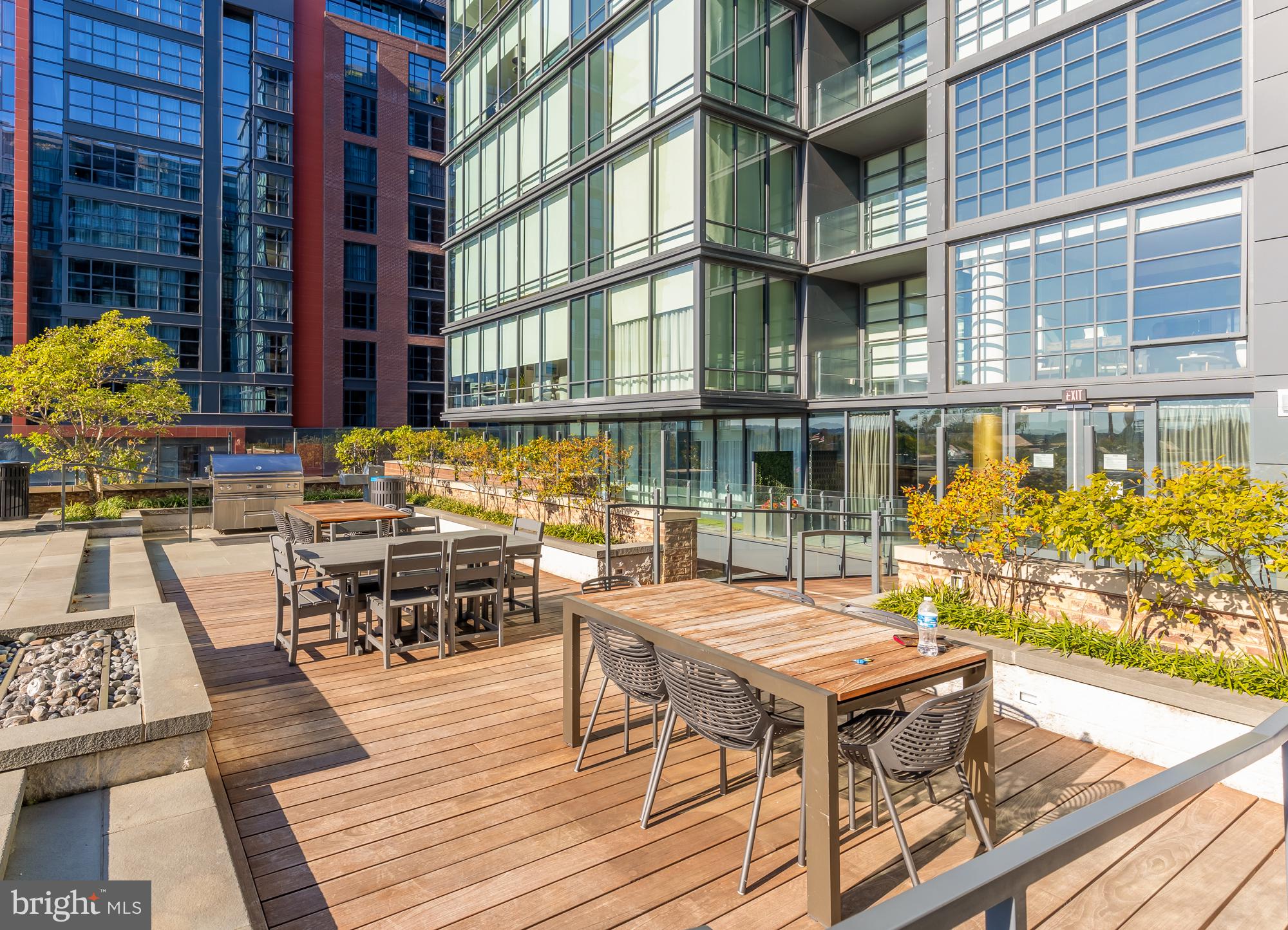 45 Sutton Square Southwest, Unit 706 Washington, DC 20024 - Photo 41 of 51 a view of a patio with table and chairs and wooden floor