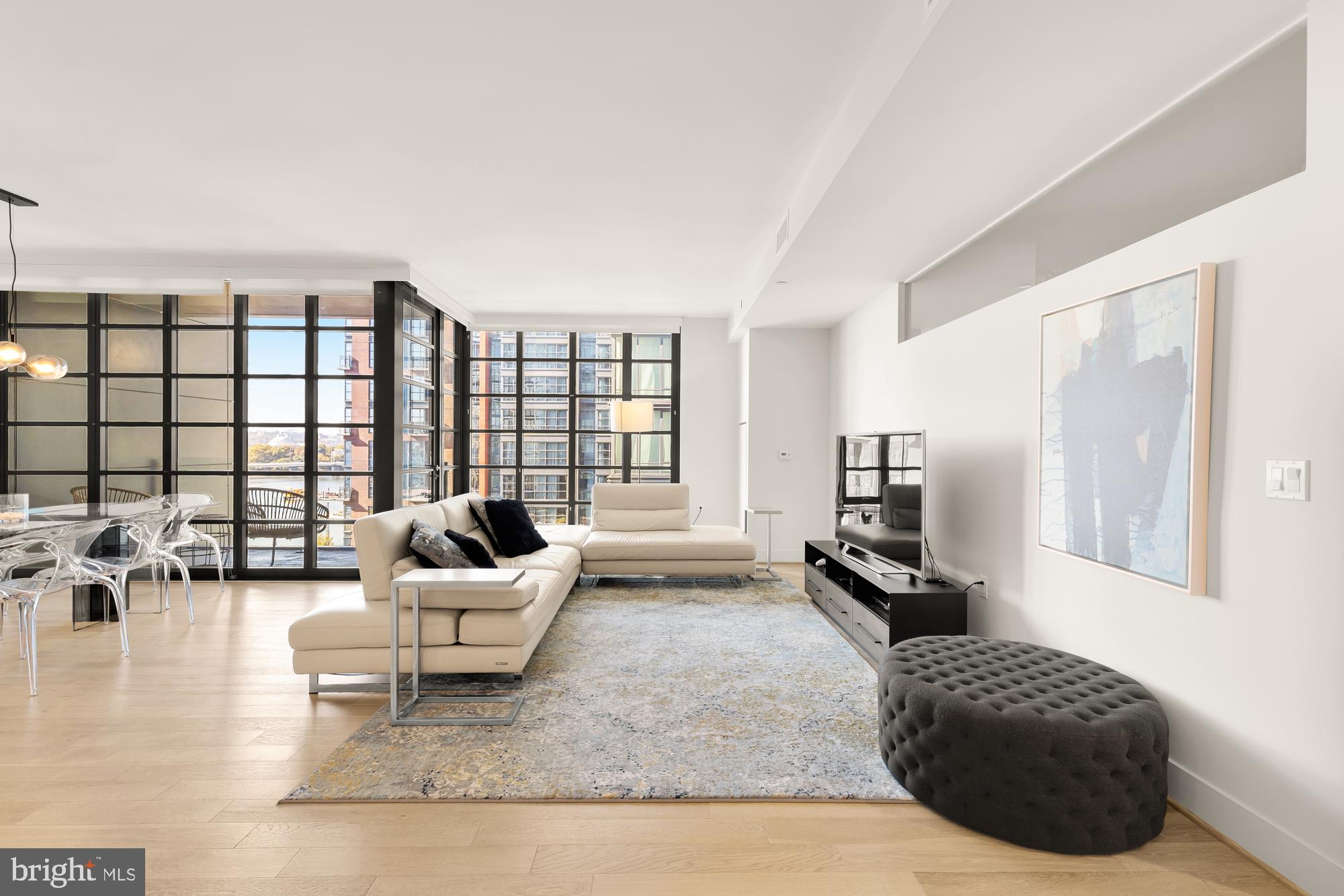 45 Sutton Square Southwest, Unit 706 Washington, DC 20024 - Photo 5 of 51 a living room with furniture and a flat screen tv