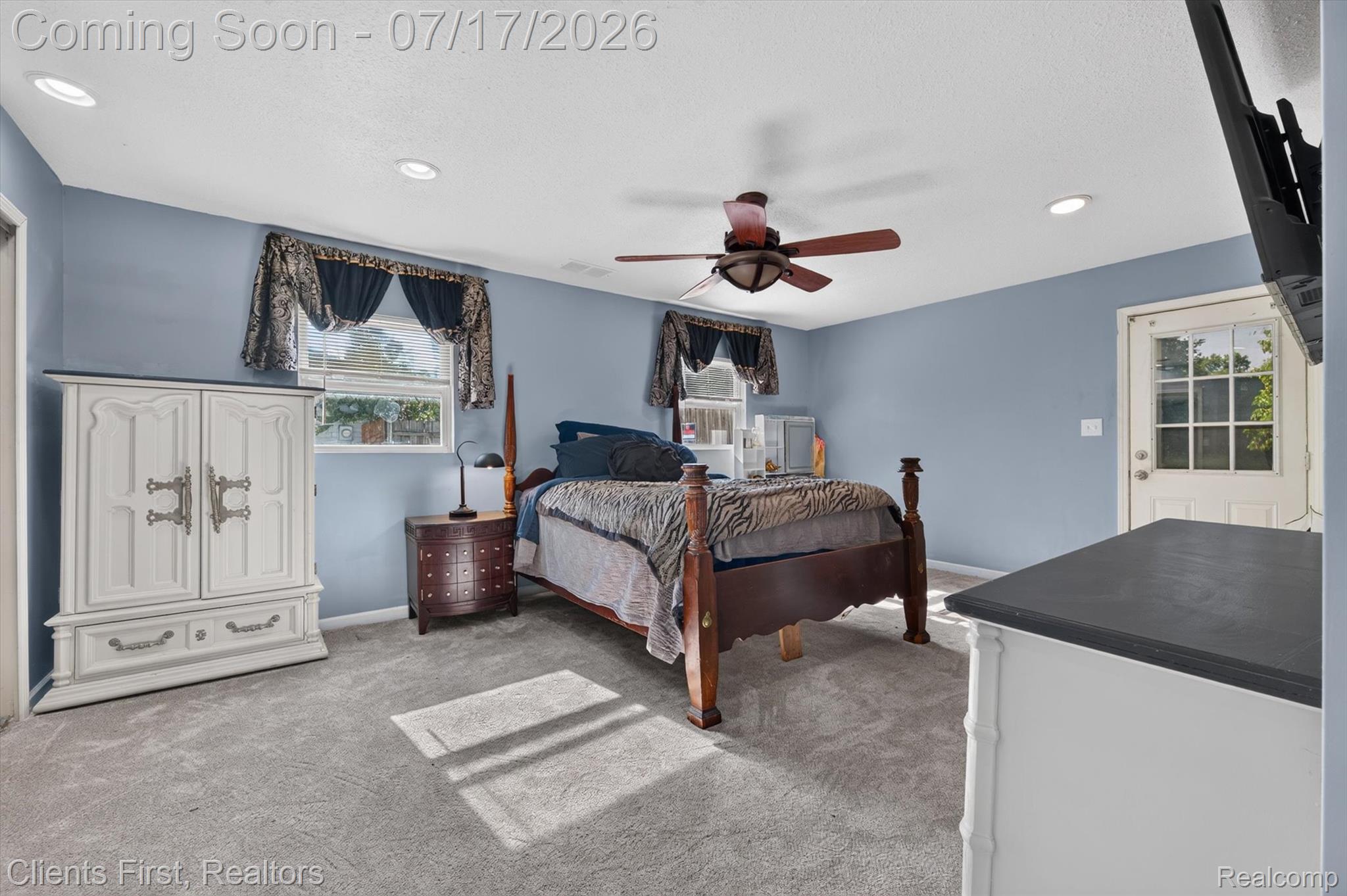 36852 Chase Street Romulus, MI 48174 - Photo 15 of 40 Spacious room featuring light blue walls, gray carpeting, a multi-pane door with exterior access, and recessed ceiling lighting